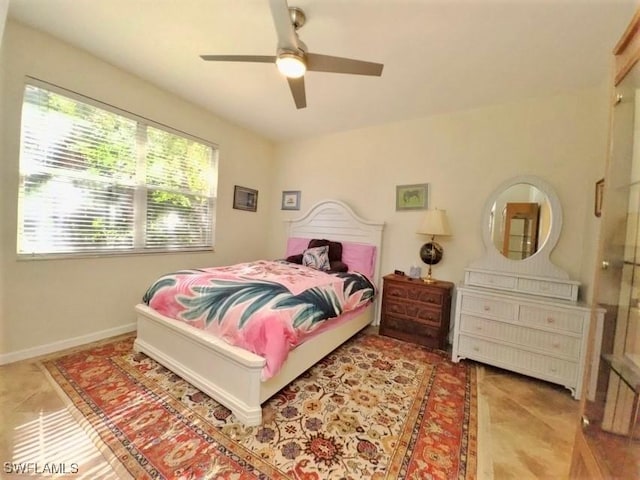 tiled bedroom featuring ceiling fan