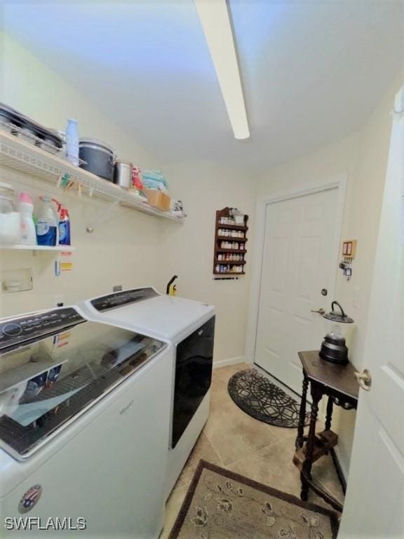 laundry area featuring washer and dryer and light tile patterned floors