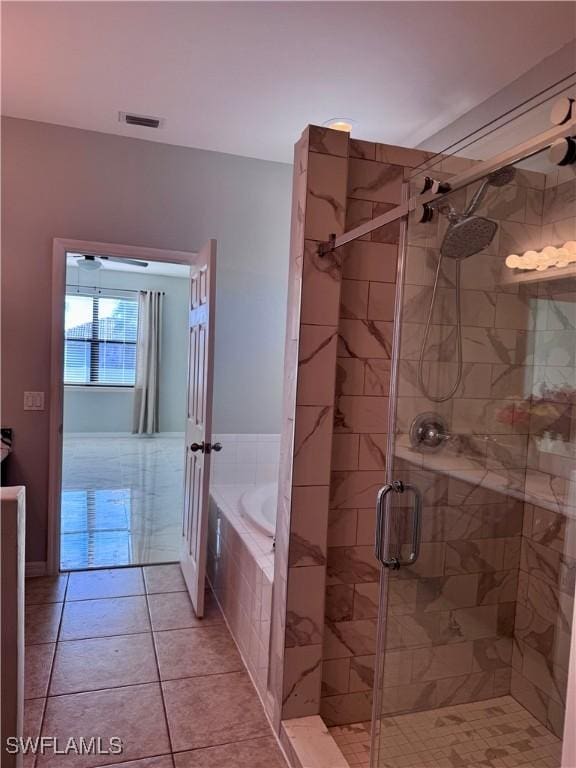 bathroom featuring plus walk in shower and tile patterned flooring