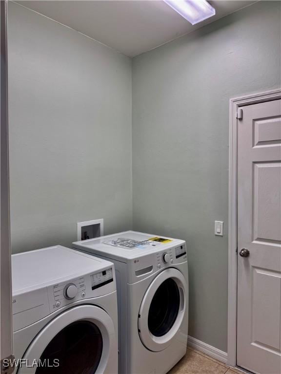 washroom featuring separate washer and dryer and light tile patterned flooring