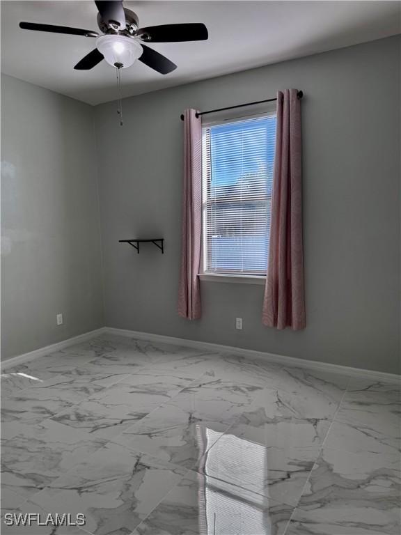 unfurnished room with ceiling fan