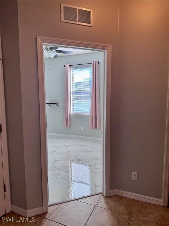 hallway with light tile patterned flooring