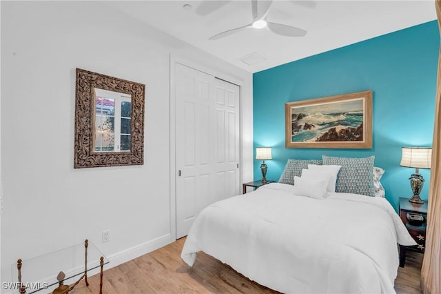 bedroom featuring ceiling fan, a closet, and light wood-type flooring