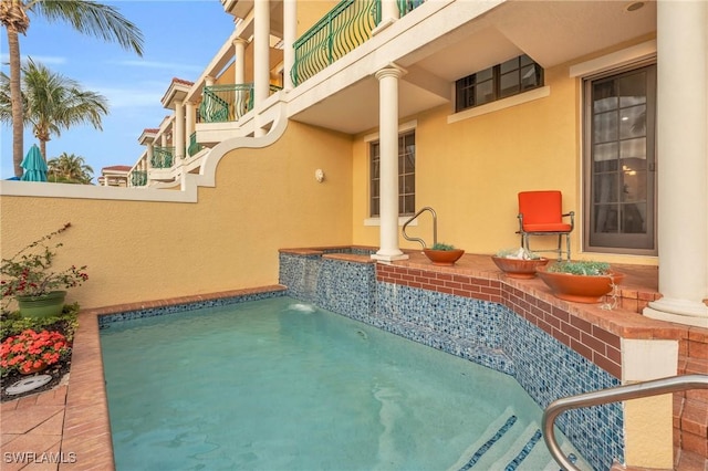 view of swimming pool featuring pool water feature