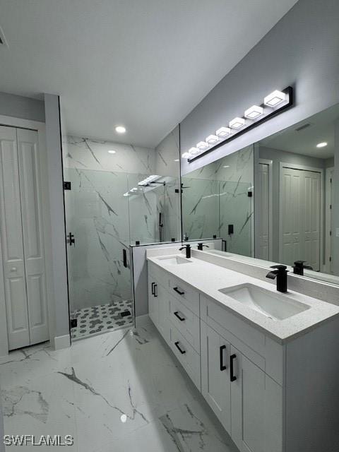 bathroom with vanity and a shower with shower door