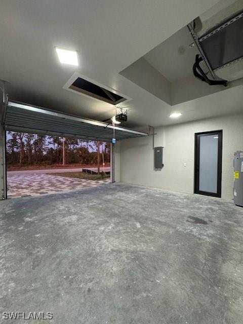 garage featuring electric water heater and electric panel