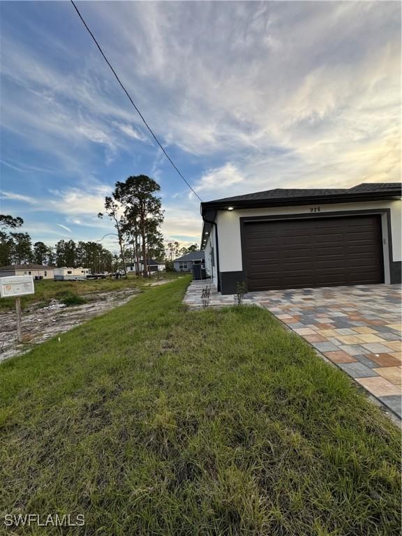 exterior space featuring a front lawn and a garage