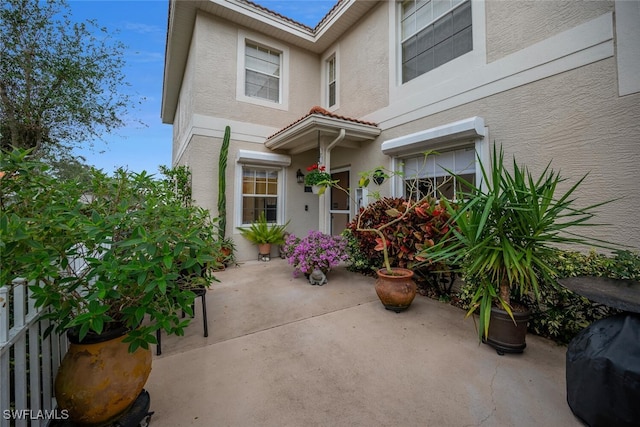 property entrance featuring a patio area