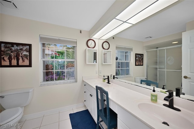 bathroom with tile patterned floors, toilet, a shower with shower door, and vanity