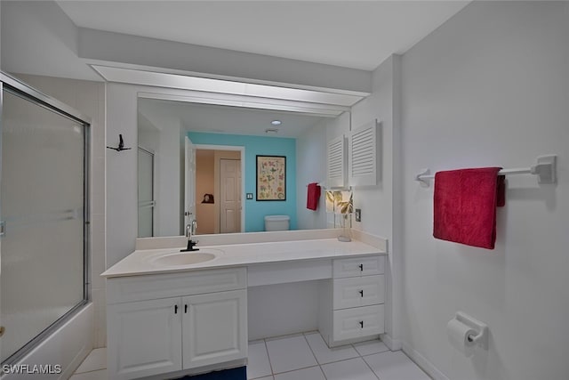 full bathroom with vanity, bath / shower combo with glass door, tile patterned floors, and toilet