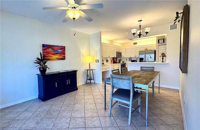 dining room featuring light tile patterned floors and ceiling fan with notable chandelier