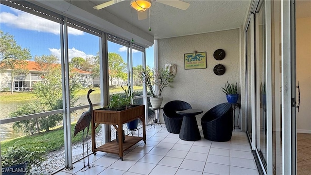 sunroom featuring ceiling fan