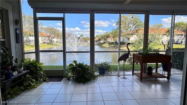 unfurnished sunroom with a water view