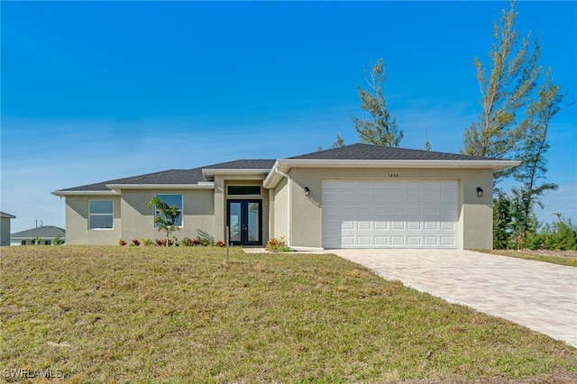 ranch-style house featuring a front lawn, a garage, and french doors