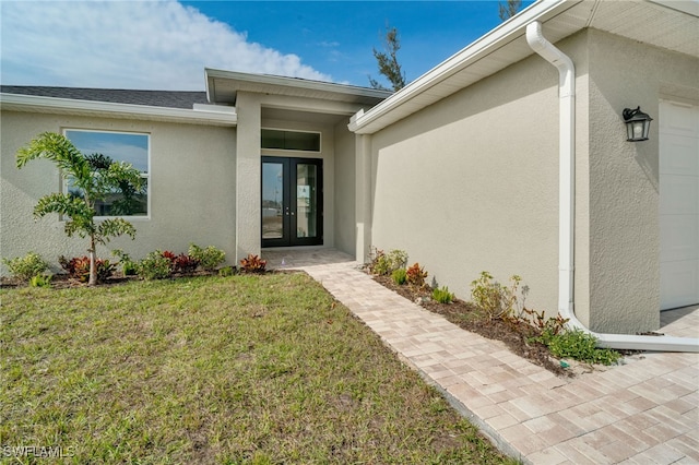 doorway to property featuring french doors and a yard