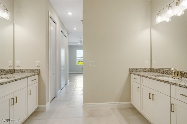 bathroom with ceiling fan, tile patterned flooring, and vanity