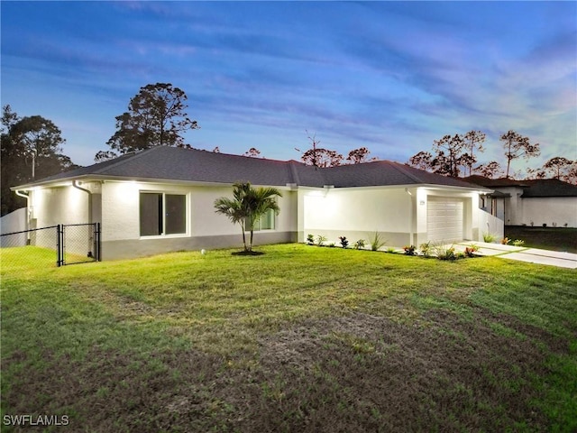 view of front of home featuring a garage and a lawn