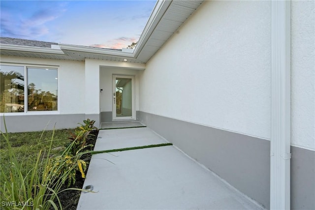 3306 E 7th St, Lehigh Acres, FL 33972 - exterior entry at dusk with stucco siding
