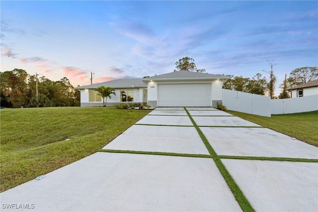 view of front of home featuring a yard and a garage