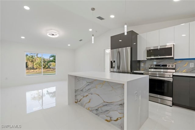 3306 E 7th St, Lehigh Acres, FL 33972 - kitchen featuring stainless steel appliances, modern cabinets, light countertops, pendant lighting, and tasteful backsplash