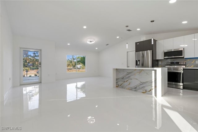 kitchen featuring white cabinetry, a healthy amount of sunlight, stainless steel appliances, and decorative light fixtures