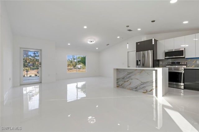 3306 E 7th St, Lehigh Acres, FL 33972 - unfurnished living room featuring lofted ceiling, recessed lighting, and light tile patterned floors