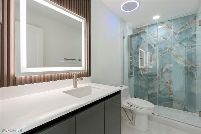 bathroom with an enclosed shower, vanity, and toilet