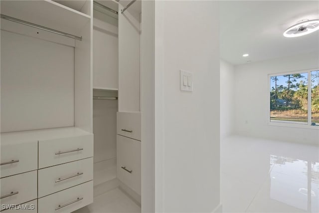 spacious closet featuring light tile patterned floors