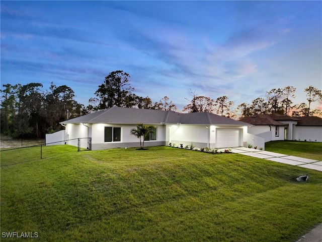 3306 E 7th St, Lehigh Acres, FL 33972 - view of front of house with driveway, an attached garage, and stucco siding
