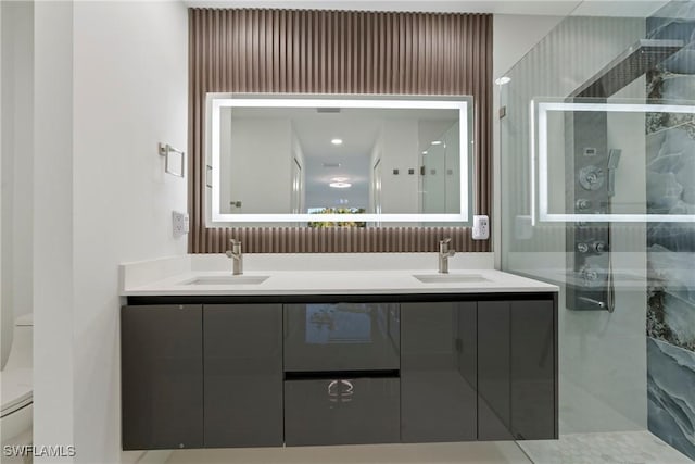 bathroom with vanity, an enclosed shower, and toilet