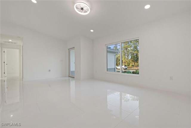 3306 E 7th St, Lehigh Acres, FL 33972 - spare room with tile patterned floors and recessed lighting