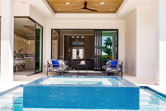 view of swimming pool featuring a bar, ceiling fan, an outdoor hangout area, and an in ground hot tub