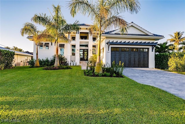 view of front of house featuring a garage and a front lawn