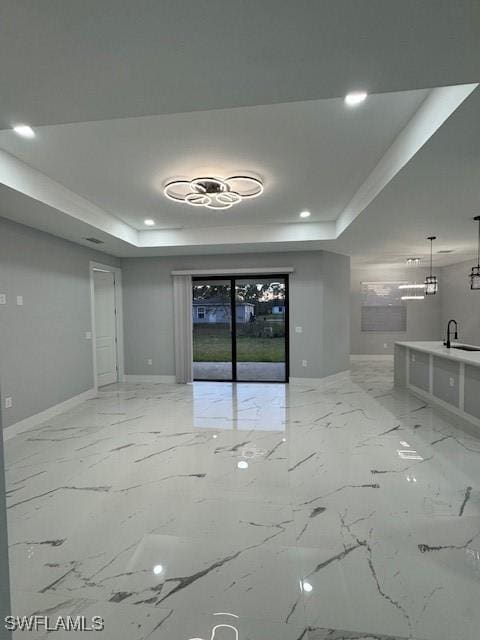 unfurnished room featuring a raised ceiling