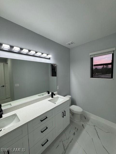 bathroom with vanity and toilet