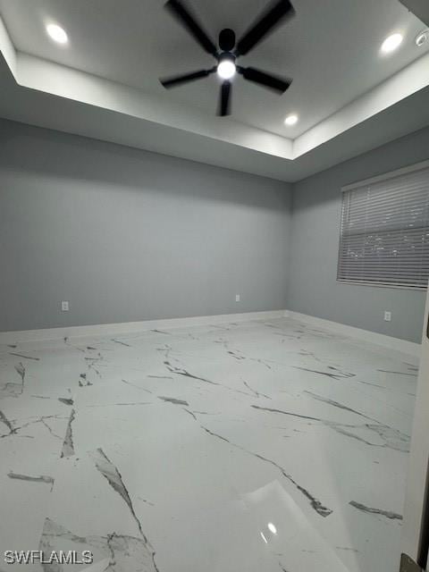 spare room with a tray ceiling