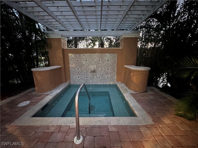 view of pool featuring a pergola and an in ground hot tub