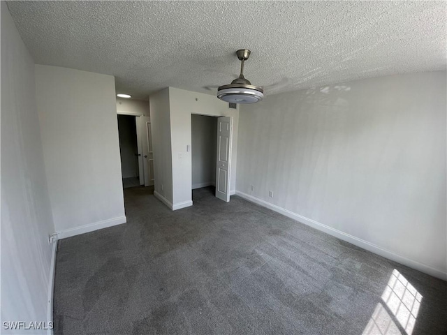 1275 Wildwood Lakes Blvd Unit 105, Naples, FL 34104 - unfurnished bedroom featuring carpet flooring, baseboards, and a textured ceiling