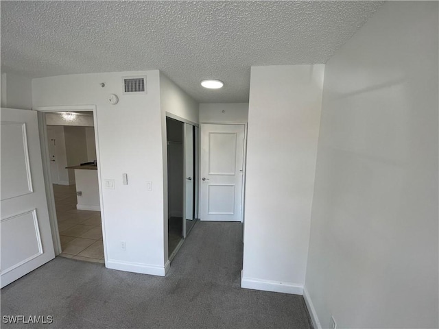 1275 Wildwood Lakes Blvd Unit 105, Naples, FL 34104 - interior space with a textured ceiling, baseboards, and visible vents