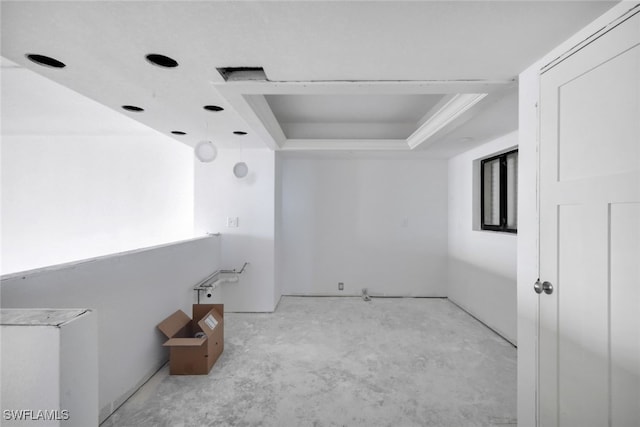 spare room featuring a tray ceiling and ornamental molding