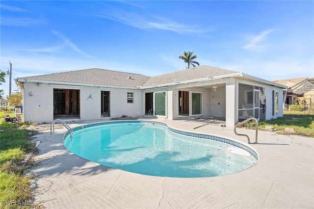 view of pool with a sunroom and a patio