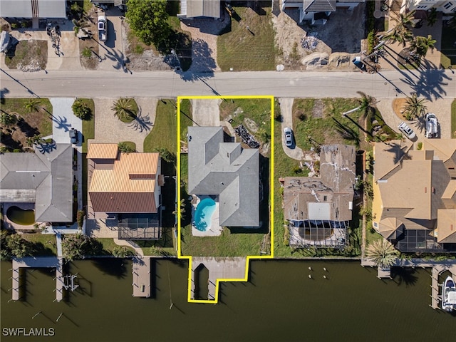 birds eye view of property with a water view