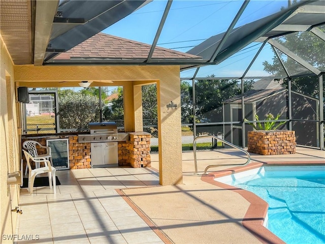 view of pool with exterior kitchen, a lanai, and a patio