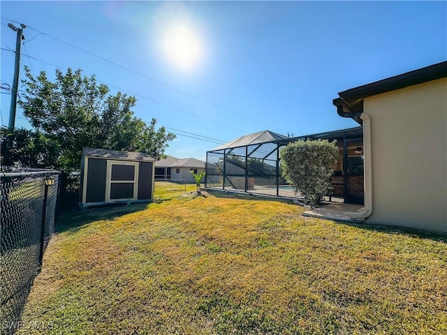 view of yard with a lanai and a shed