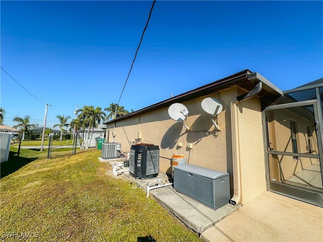 view of home's exterior featuring a lawn and cooling unit