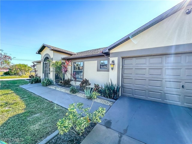 view of front of house with a garage and a front yard