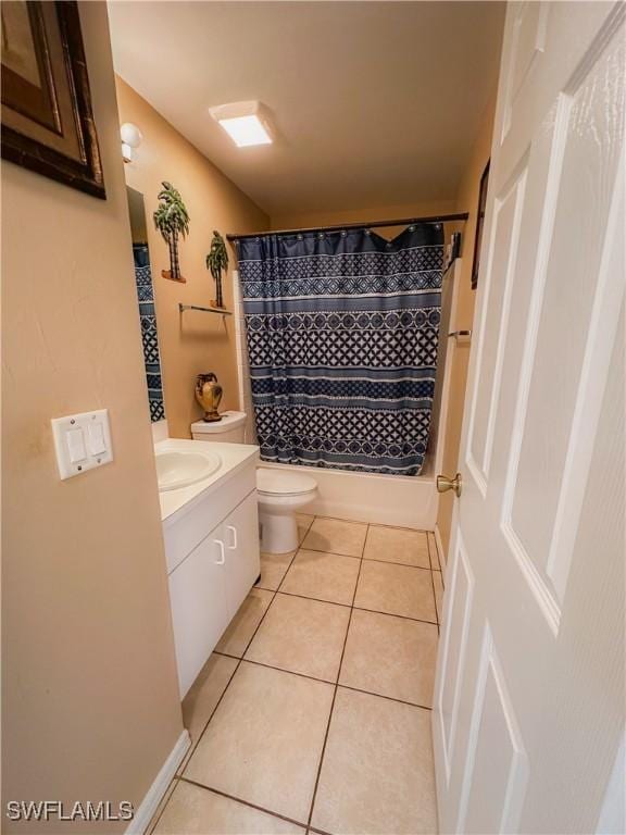 full bathroom with shower / bathtub combination with curtain, vanity, tile patterned floors, and toilet