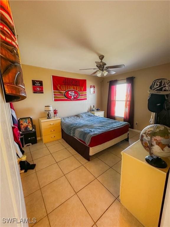 tiled bedroom featuring ceiling fan