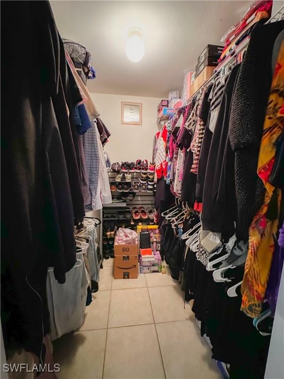 spacious closet with tile patterned floors