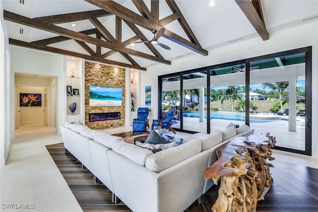 living room with beamed ceiling, built in shelves, ceiling fan, and a fireplace